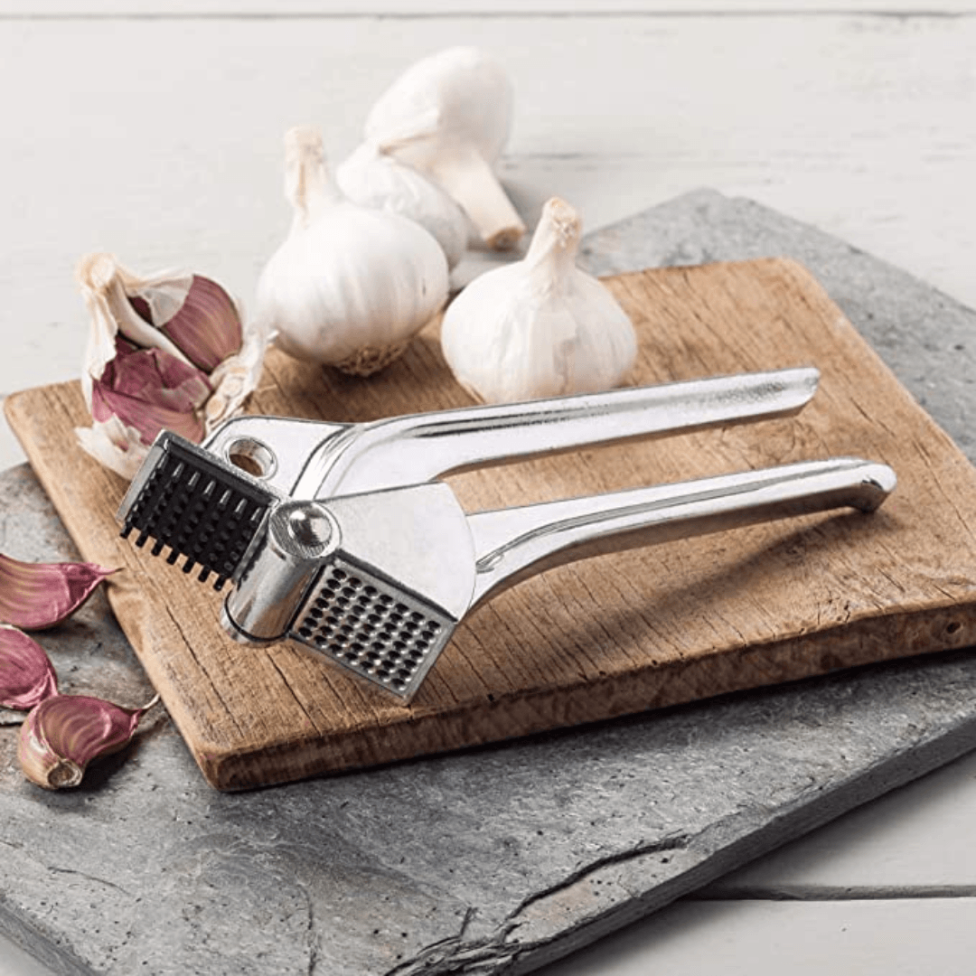 Royal Industries 7 inch Aluminum Garlic Press This garlic press features pressing nubs that force the garlic through a stainless steel blade. It is extremely easy cleaning and won't leave your hands smelling like garlic all day-ROY GP Hannah's Variety Store