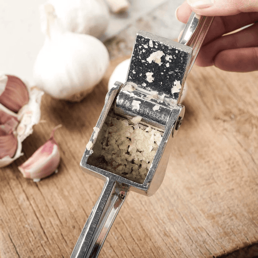 Royal Industries 7 inch Aluminum Garlic Press This garlic press features pressing nubs that force the garlic through a stainless steel blade. It is extremely easy cleaning and won't leave your hands smelling like garlic all day-ROY GP Hannah's Variety Store