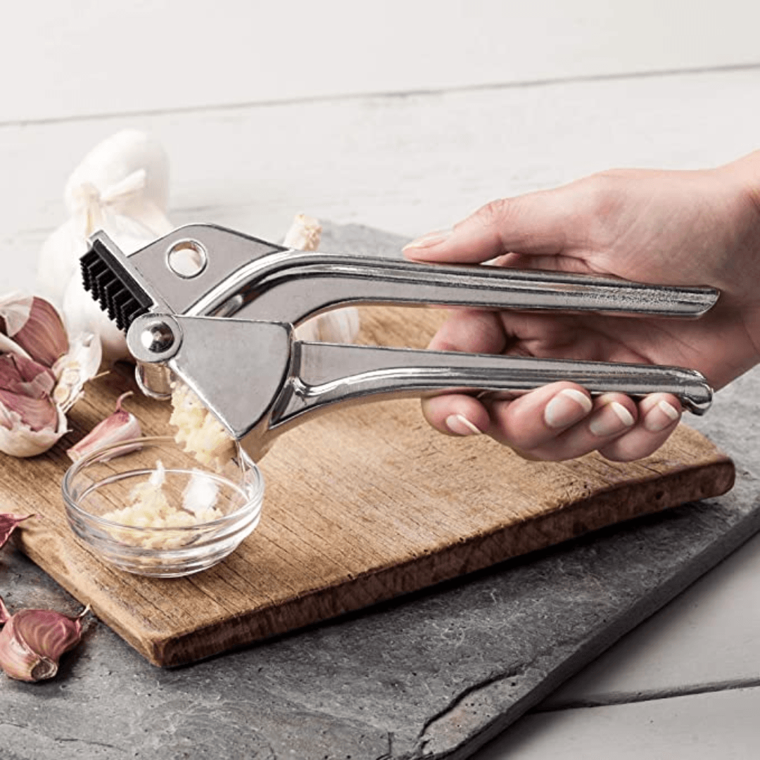 Royal Industries 7 inch Aluminum Garlic Press  This garlic press features pressing nubs that force the garlic through a stainless steel blade. It is extremely easy cleaning and won't leave your hands smelling like garlic all day-ROY GP Hannah's Variety Store